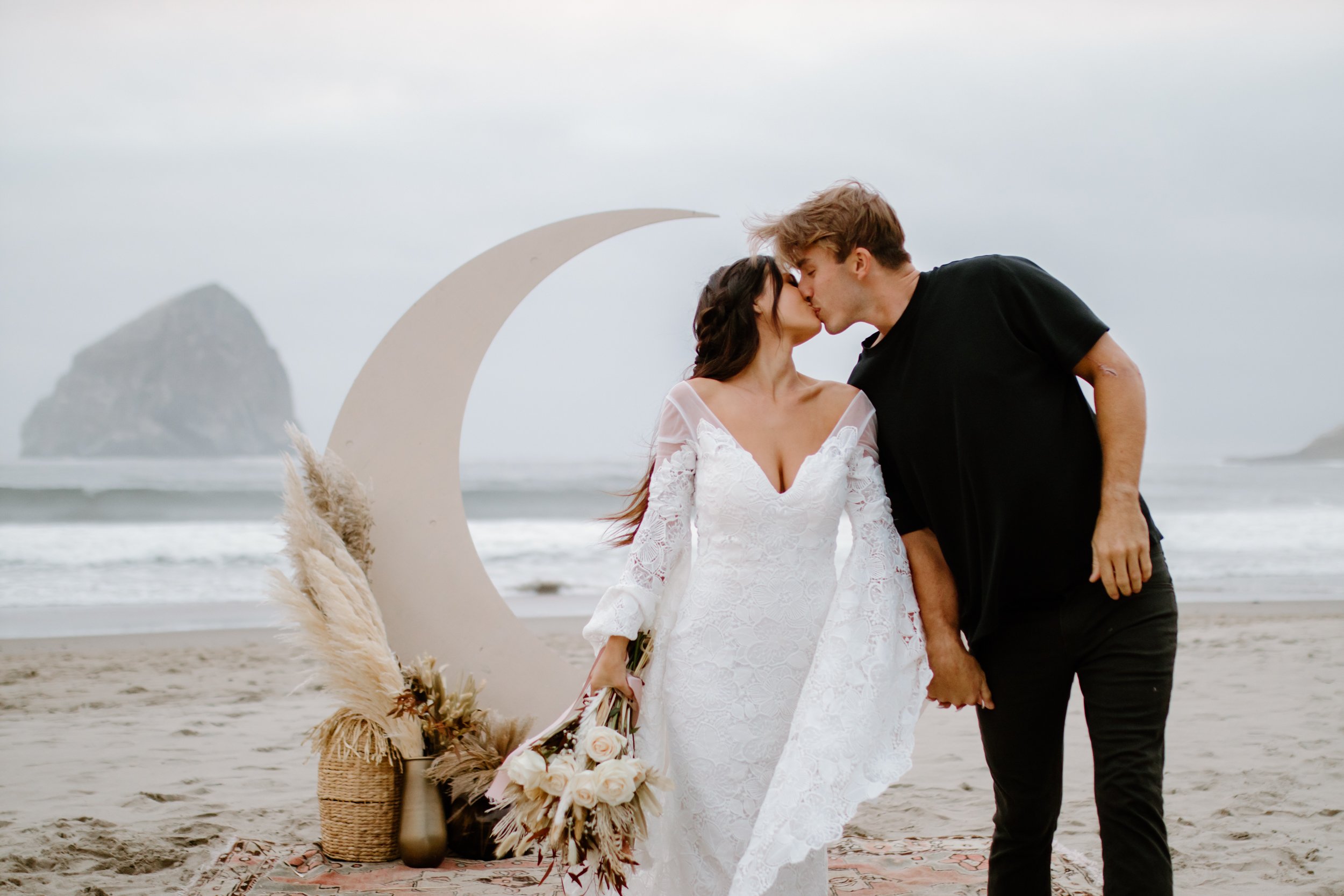 couple kissing during beach elopement ceremony on beach in Oregon