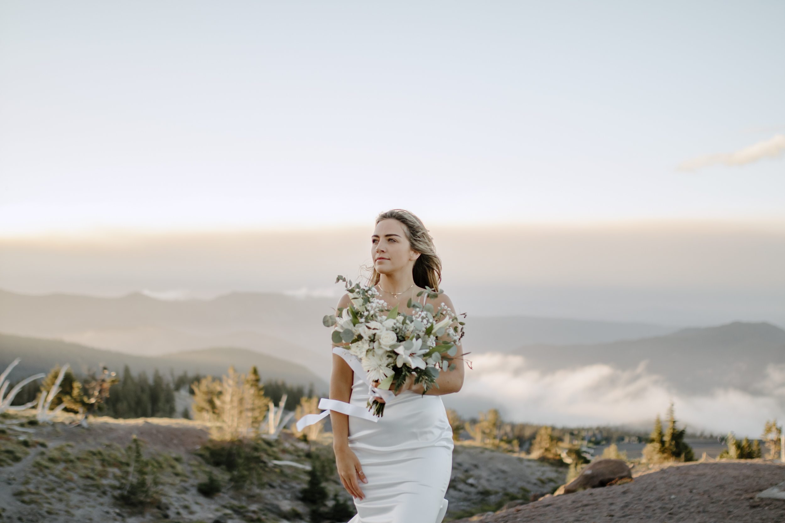 woman posing on mountain for elopement photoshoot, destination elopement photography