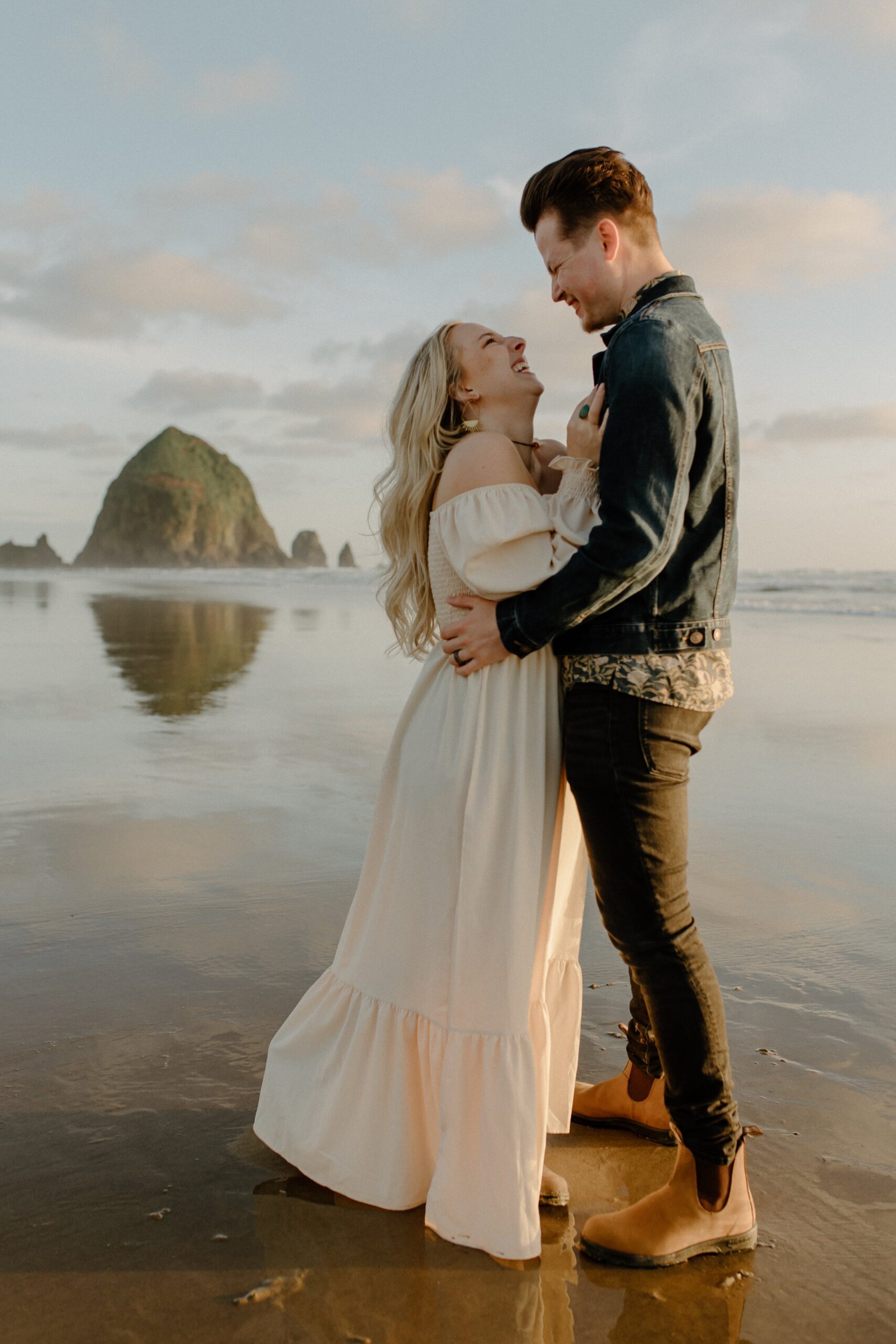  man holding woman while smiling at her on beach in Oregon, Oregon film photographer 