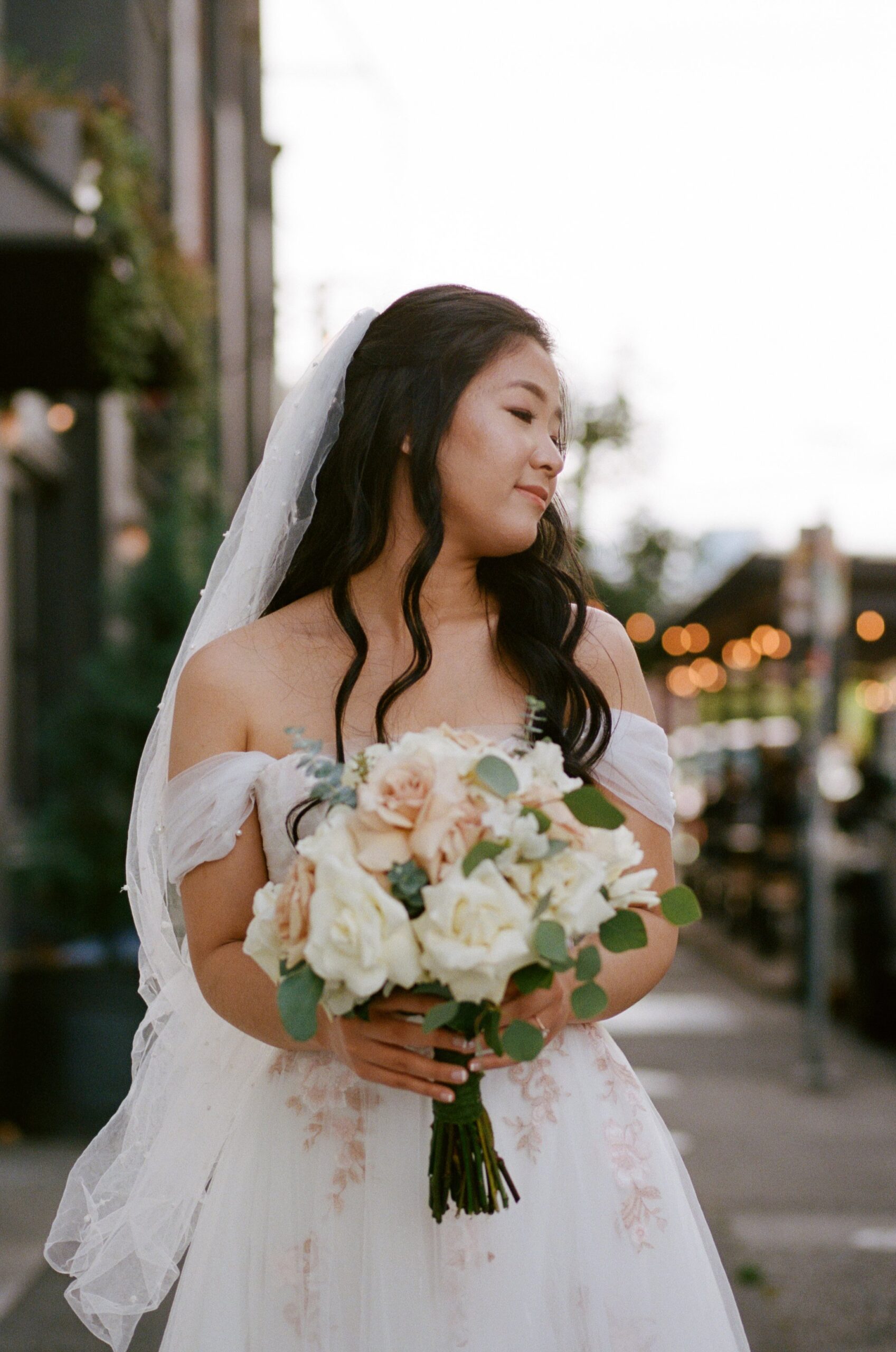 bride holding wedding bouquet while smiling. wedding photographer in Oregon