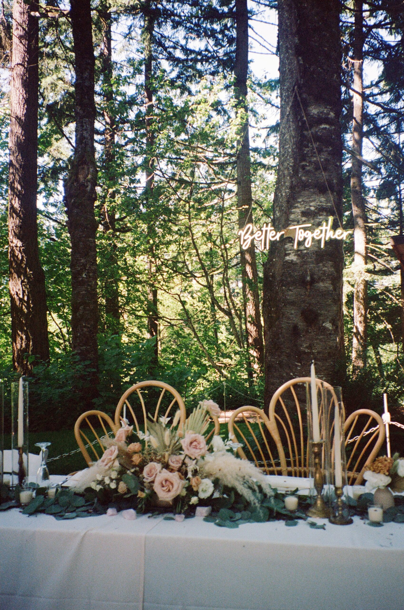 film wedding photo of wedding tablescape with led sign hung on tree. Film photography in Oregon for film photographers for weddings and engagements.