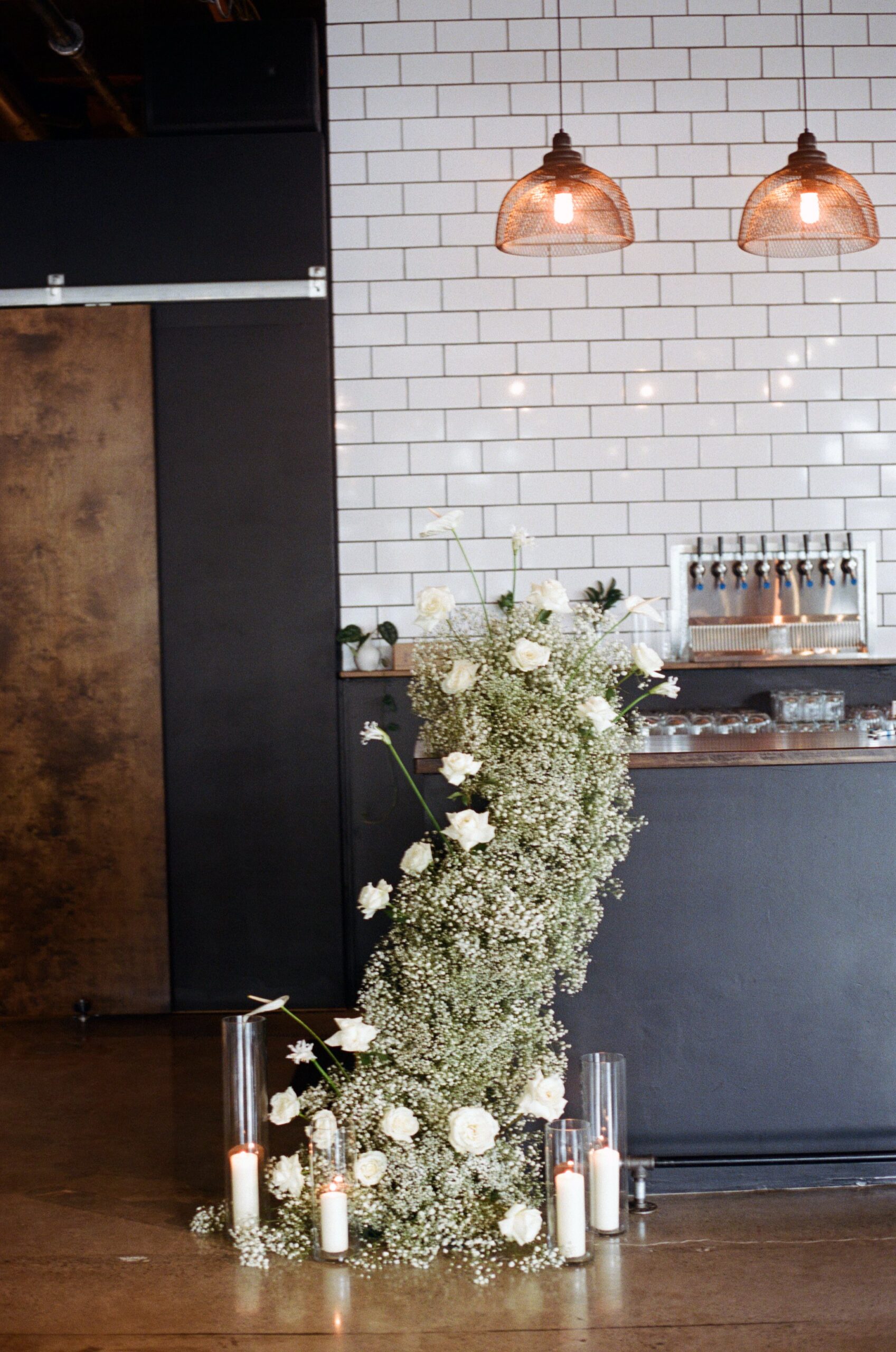 creeping flower arrangement for wedding ceremony with bar in background. film wedding photographer in oregon