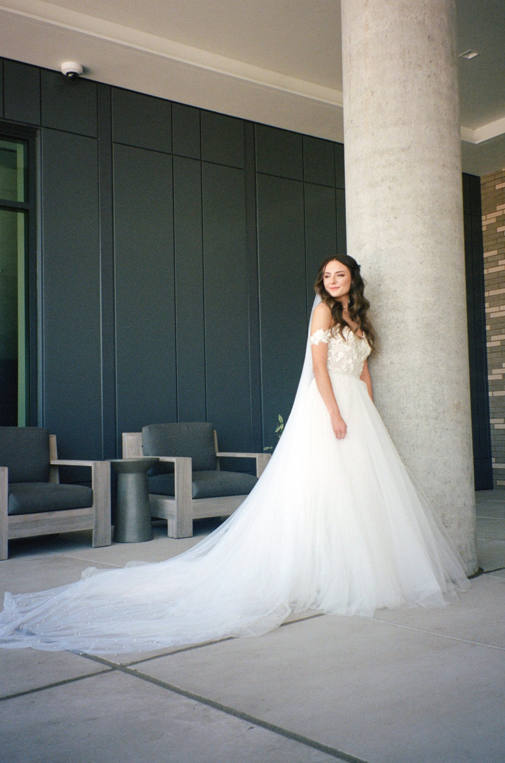 bride posing for bridal portraits in front of wedding venue in Oregon. film photographers in Oregon for wedding film photography