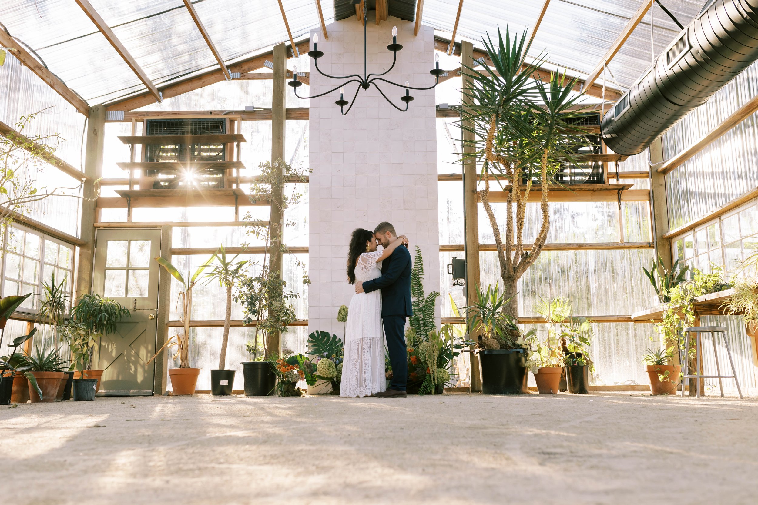 Boho chic modern greenhouse oregon summer wedding, pastels, colorful, romantic, couple standing at alter, sweet moment alone