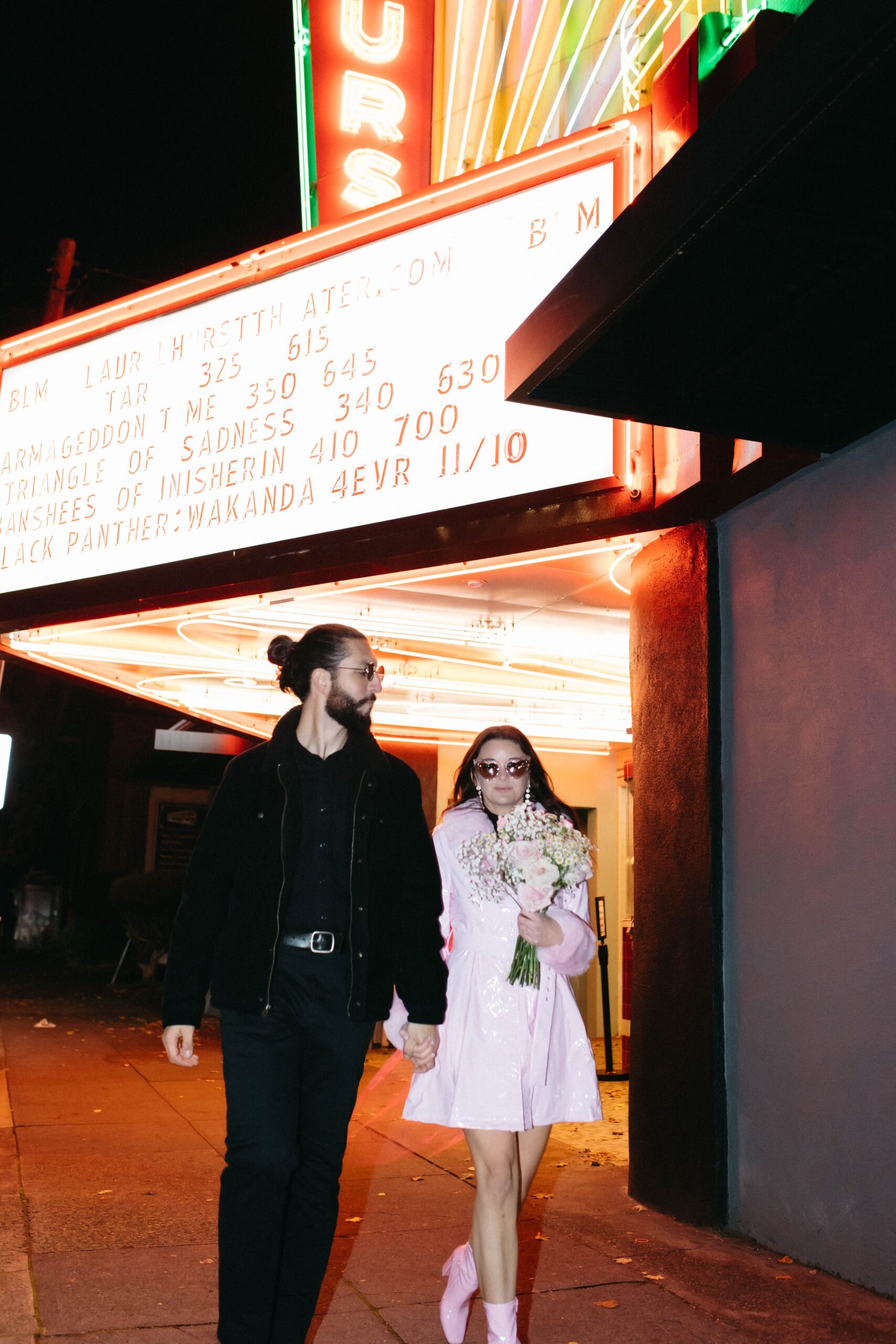  funky, modern, engagement photoshoot, neon signs, fun earrings, the unique couple poses, vegas inspired elopement nasty gal two-piece set, colorful suit, pearl gloves, movie theater, vintage, retro 