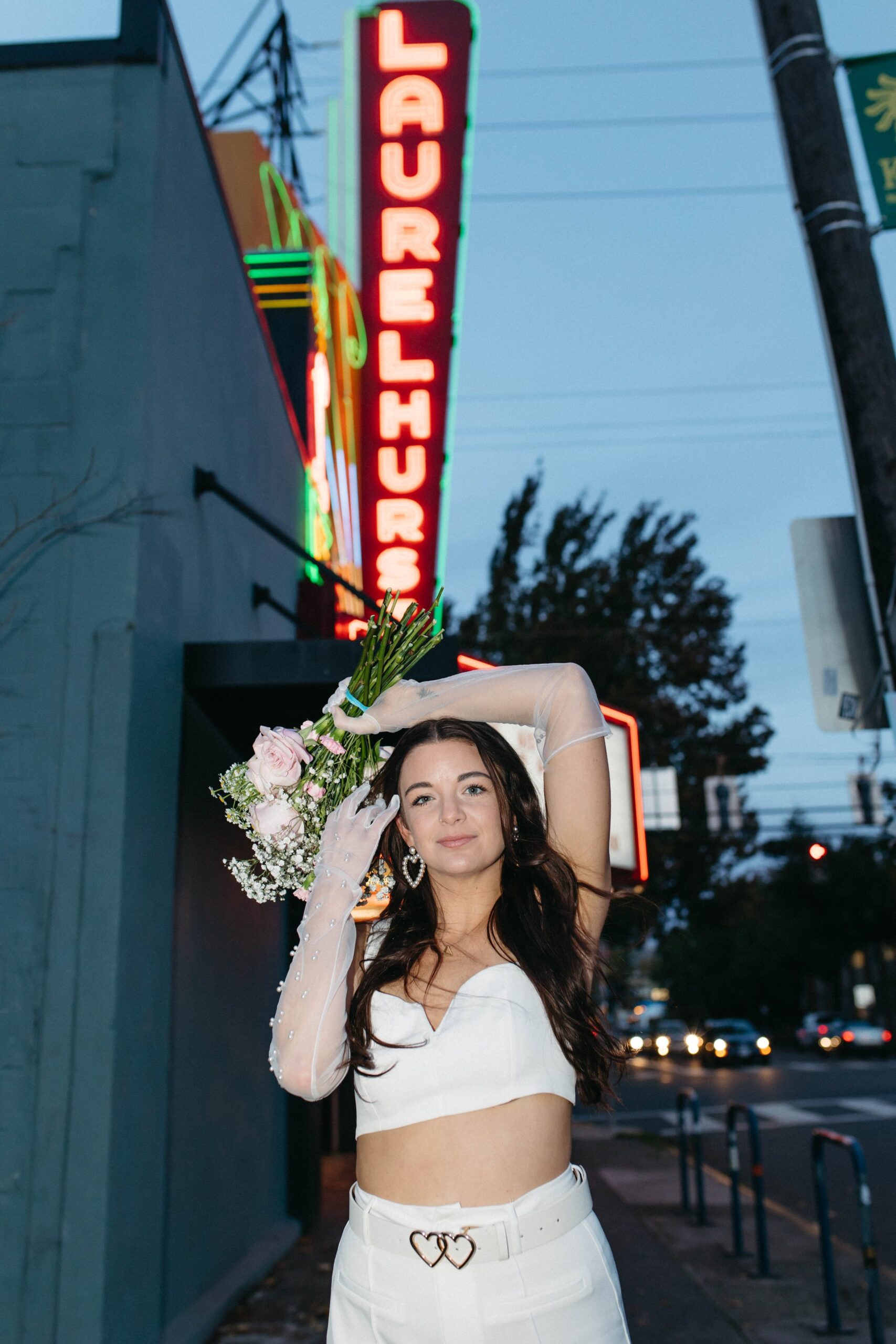  funky, modern, engagement photoshoot, neon signs, fun earrings, the unique couple poses, vegas inspired elopement nasty gal two-piece set, colorful suit, pearl gloves, movie theater, vintage, retro 