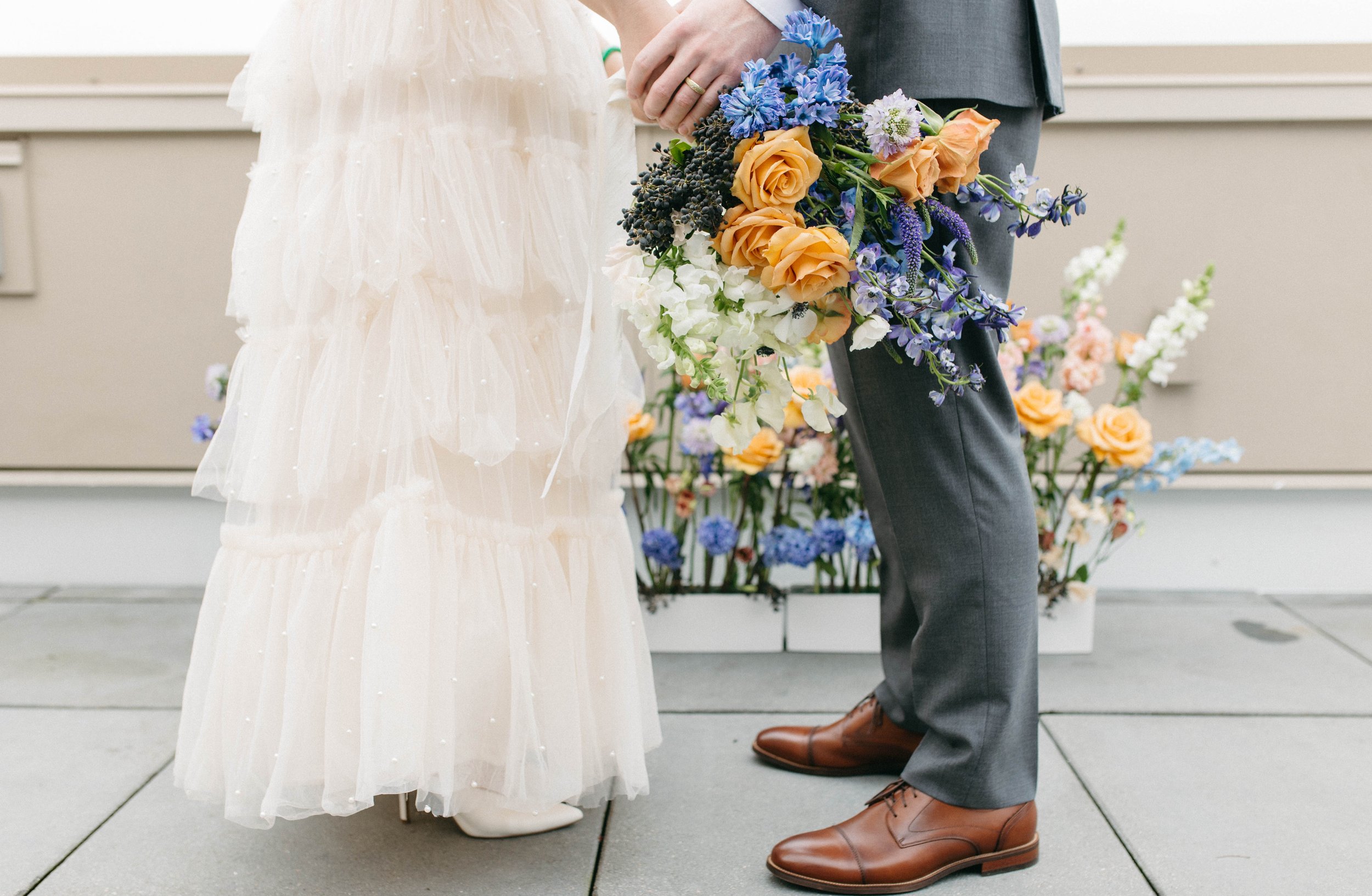  colorful whimsical small wedding elopement in Portland, Oregon. Lolo pass hotel. Purple, blue, and orange floral arrangement, fine china, beautiful place setting, private rooftop vows 