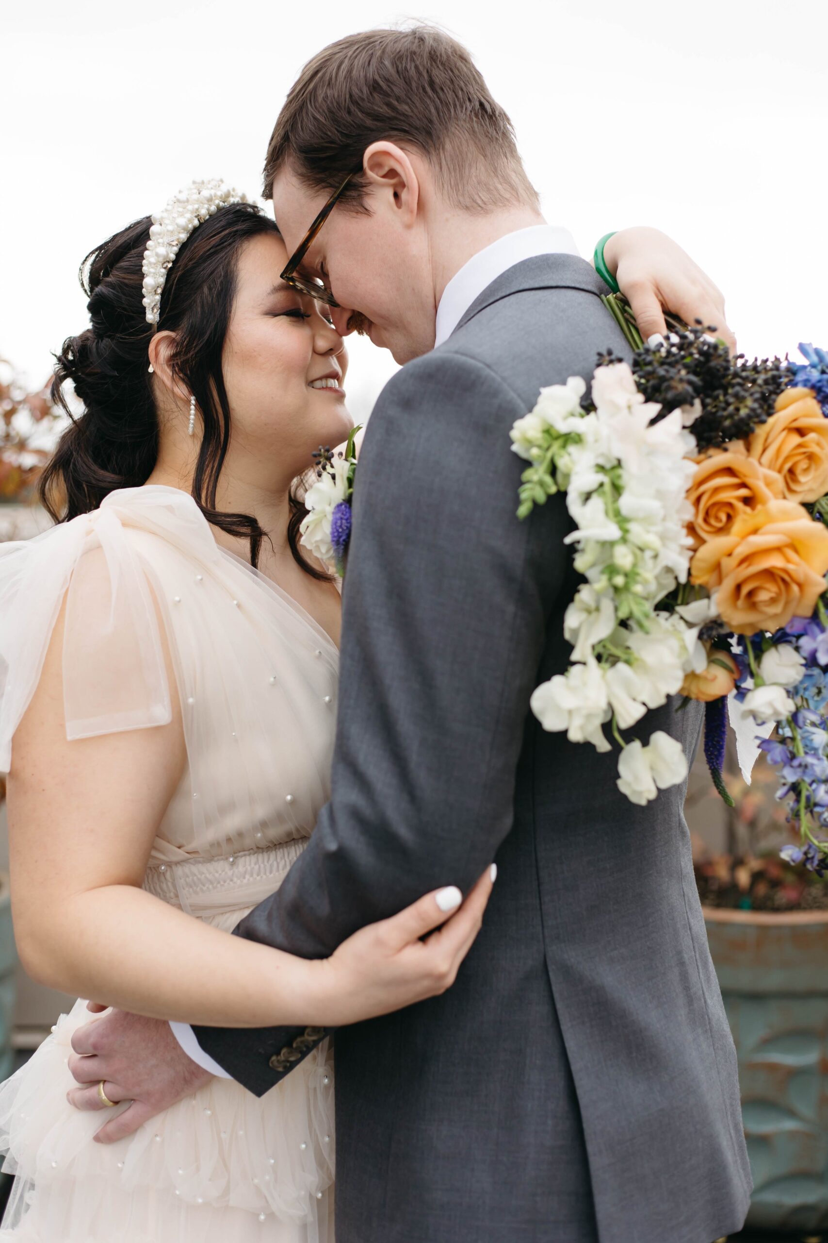  colorful whimsical small wedding elopement in Portland, Oregon. Lolo pass hotel. Purple, blue, and orange floral arrangement, fine china, beautiful place setting, private rooftop vows 